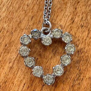 Rhinestone heart pendant on silver tone chain